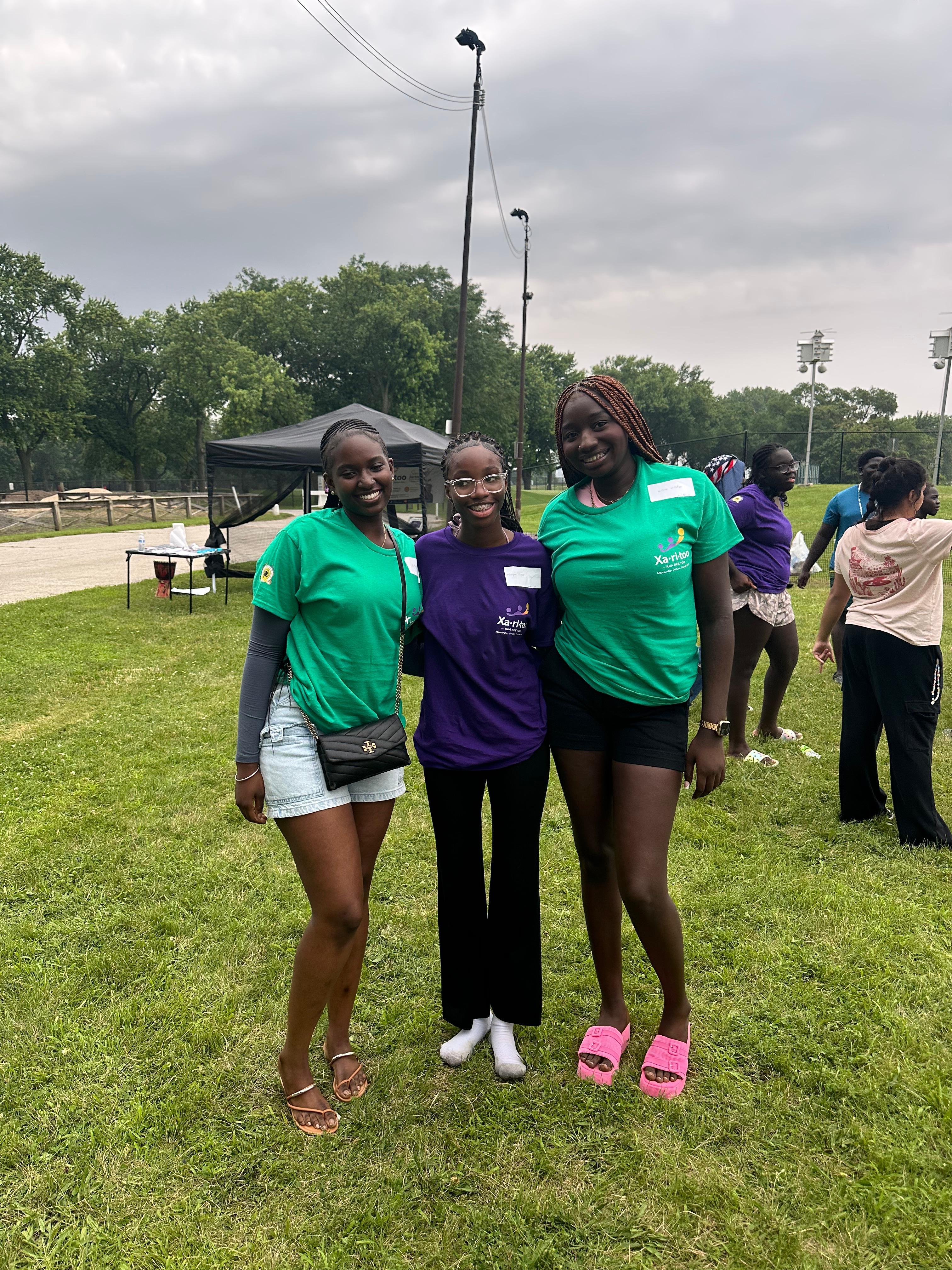Three Xaritoo participants together at an outdoor community event